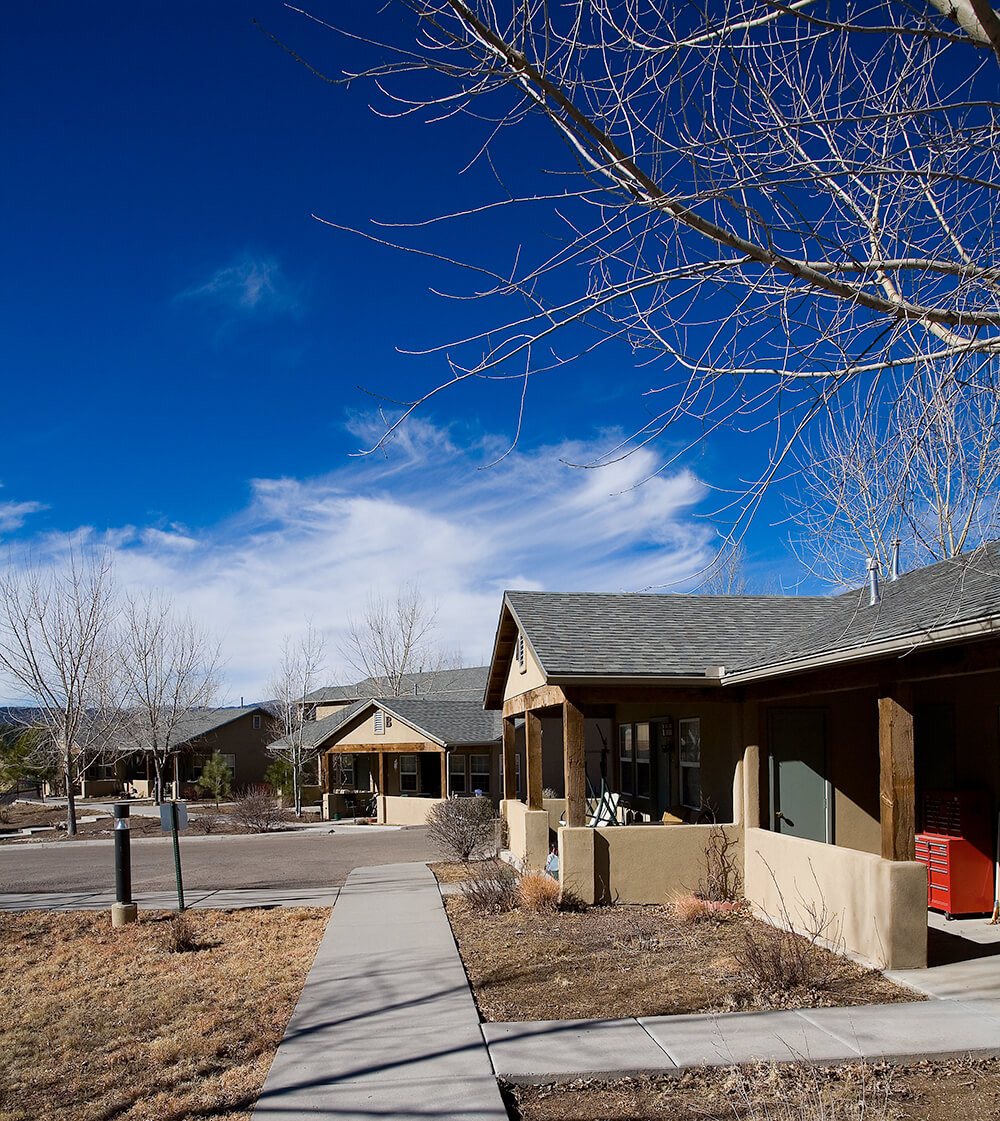 Deep blue mountain sky over cottage homes and a quiet street at La Tierra in Ruidoso, New Mexico